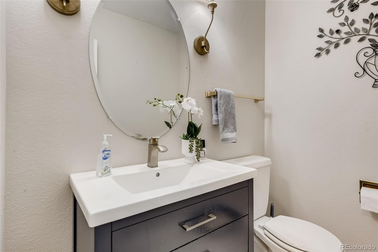9396 Desert Willow Road Highlands Ranch, CO 80129 - Photo 12 of 40 a bathroom with a sink a toilet and mirror