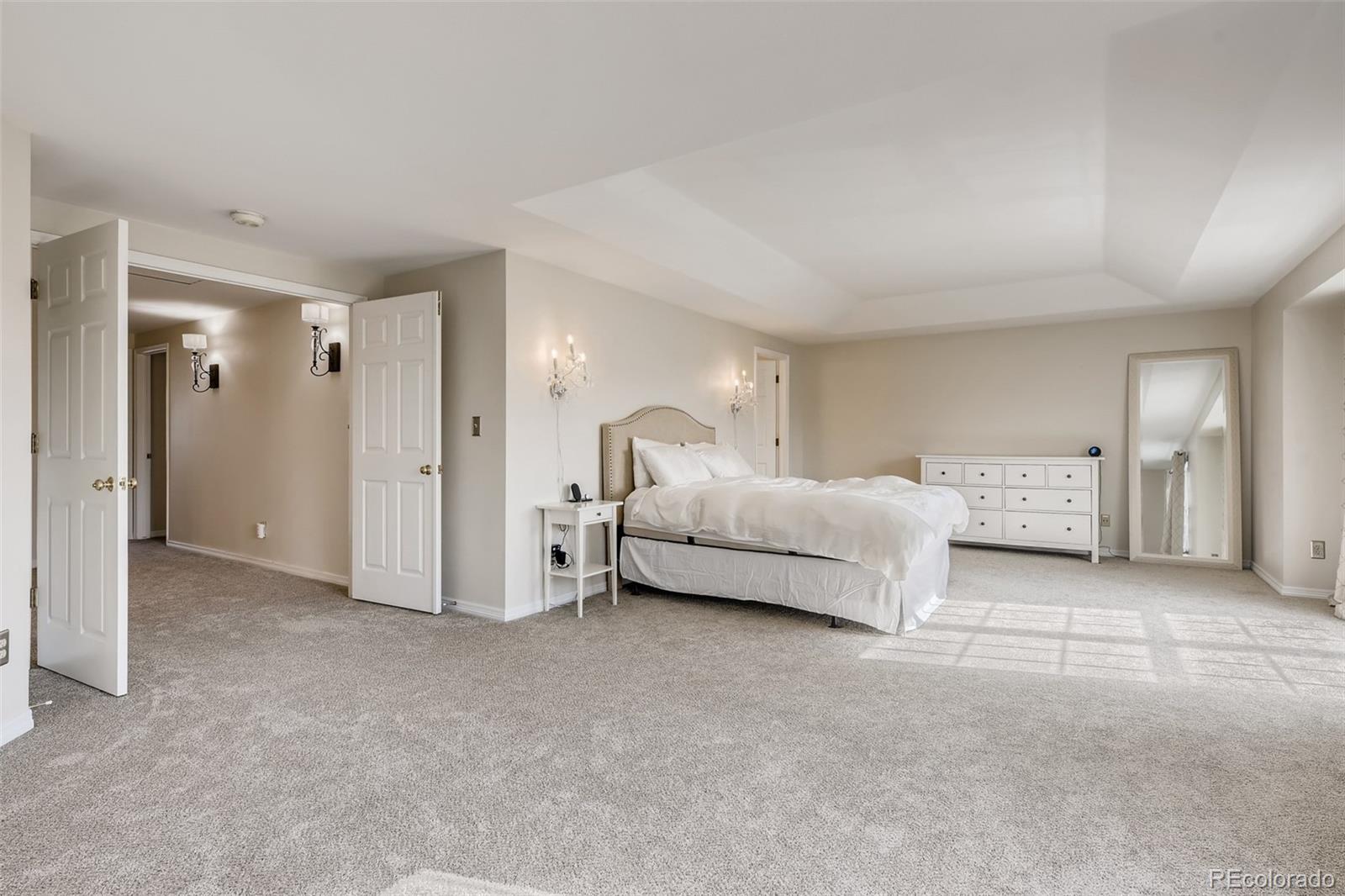 9396 Desert Willow Road Highlands Ranch, CO 80129 - Photo 14 of 40 a spacious bedroom with a bed and a lamp