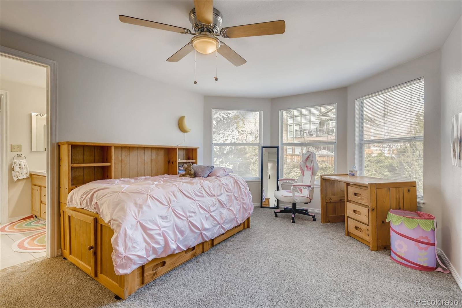 9396 Desert Willow Road Highlands Ranch, CO 80129 - Photo 18 of 40 a bedroom with a bed and a chandelier