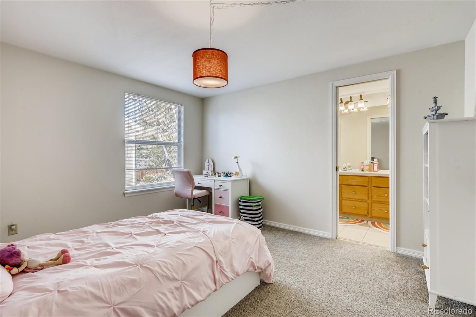 9396 Desert Willow Road Highlands Ranch, CO 80129 - Photo 19 of 40 a bedroom with a bed and a window