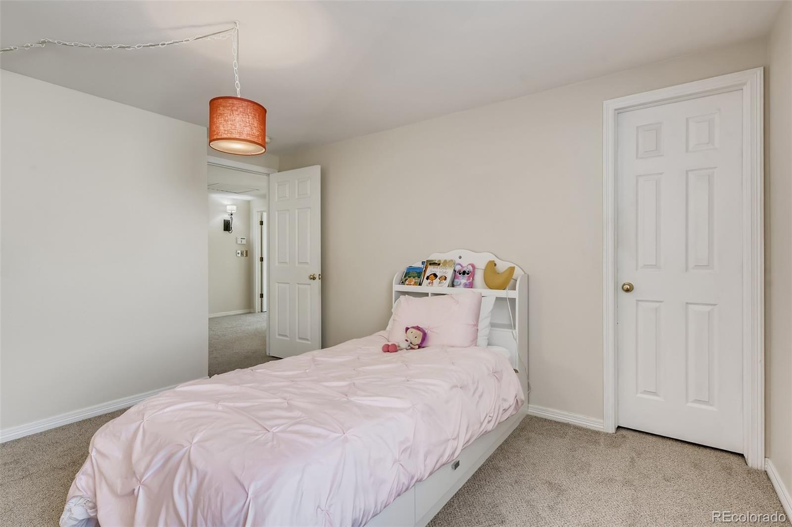 9396 Desert Willow Road Highlands Ranch, CO 80129 - Photo 20 of 40 a bedroom with a bed and a window