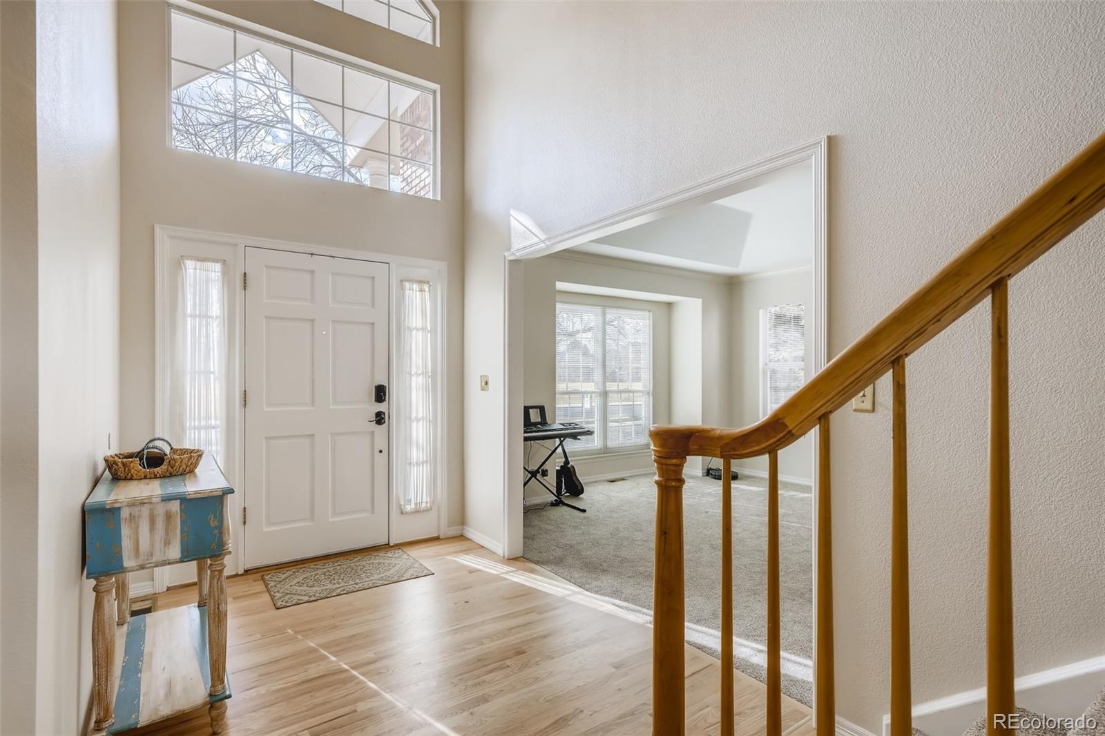 9396 Desert Willow Road Highlands Ranch, CO 80129 - Photo 2 of 40 a view of an entryway with wooden floor and stairs