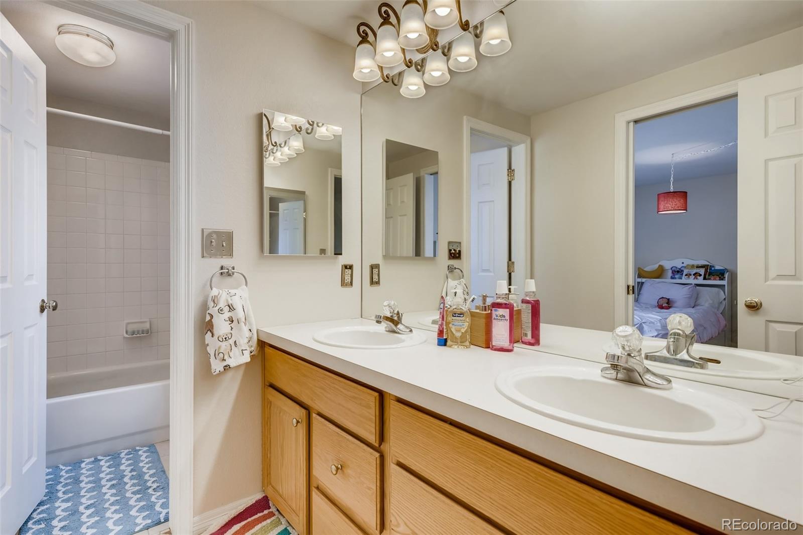 9396 Desert Willow Road Highlands Ranch, CO 80129 - Photo 22 of 40 a bathroom with a sink a shower and a mirror