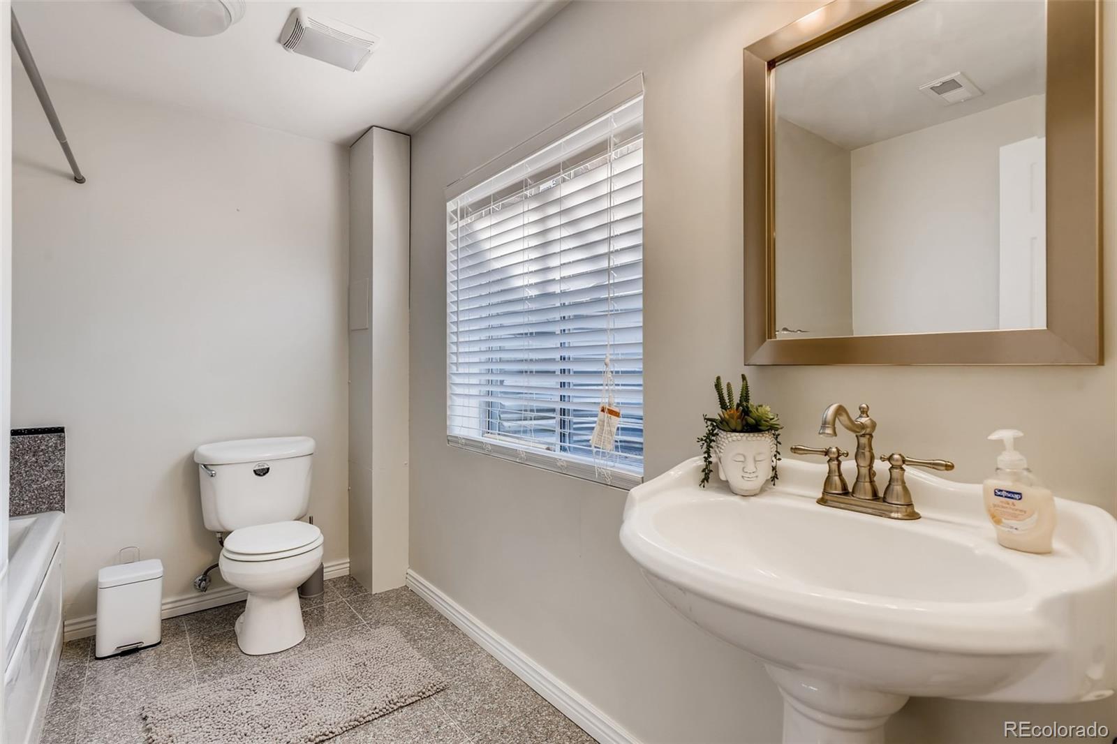 9396 Desert Willow Road Highlands Ranch, CO 80129 - Photo 23 of 40 a bathroom with a toilet sink and mirror