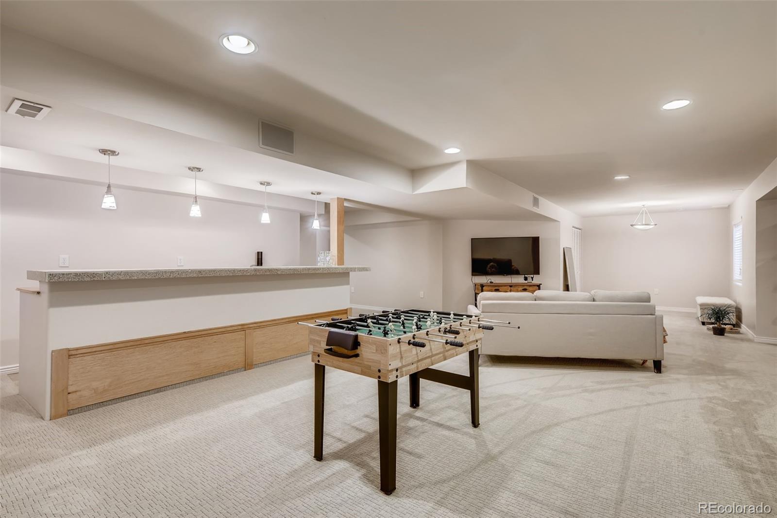 9396 Desert Willow Road Highlands Ranch, CO 80129 - Photo 24 of 40 a living room with furniture and a flat screen tv