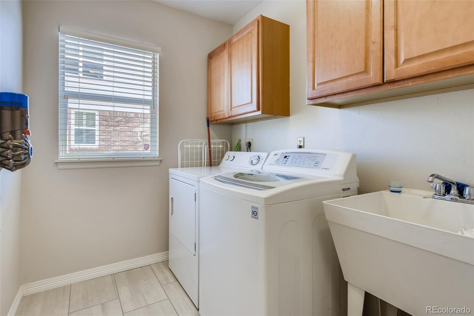 9396 Desert Willow Road Highlands Ranch, CO 80129 - Photo 30 of 40 a utility room with dryer and washer