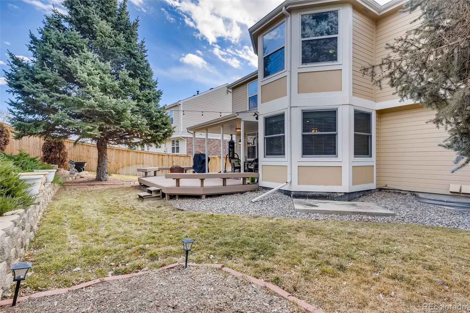 9396 Desert Willow Road Highlands Ranch, CO 80129 - Photo 35 of 40 a view of a house with backyard porch and sitting area