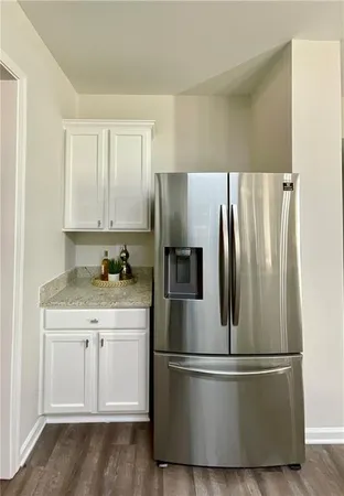 a kitchen with stainless steel appliances granite countertop a refrigerator a stove a sink and a granite counter tops