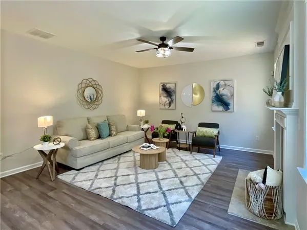 a living room with furniture and wooden floor