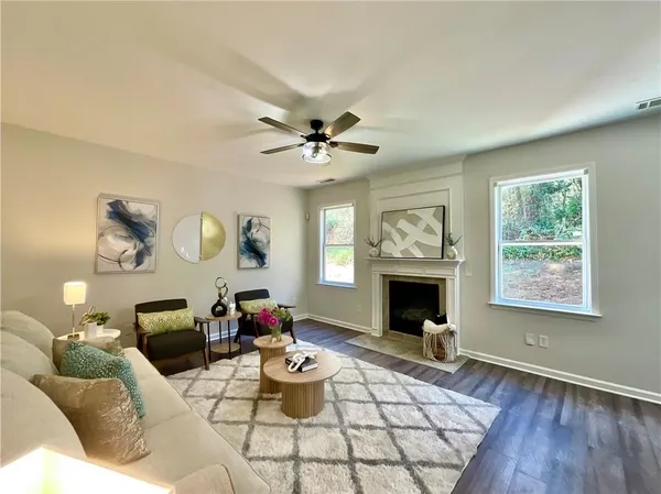 a living room with furniture chandelier and a fireplace