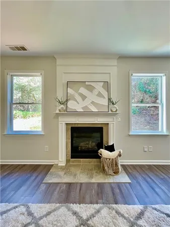 a living room with a fireplace and a window
