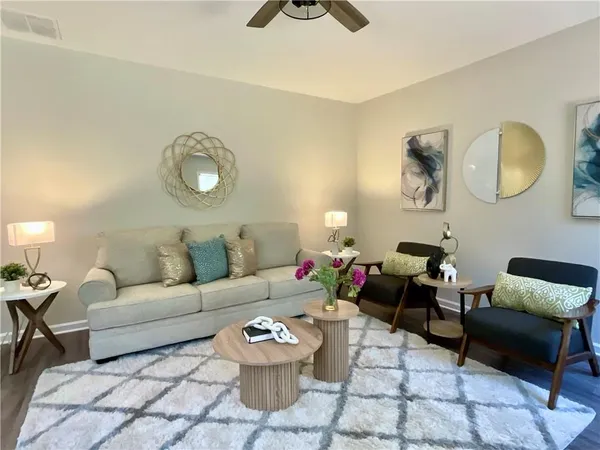 a living room with furniture and a rug