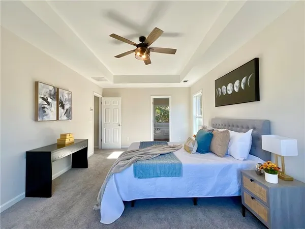 a bedroom with a bed and ceiling fan