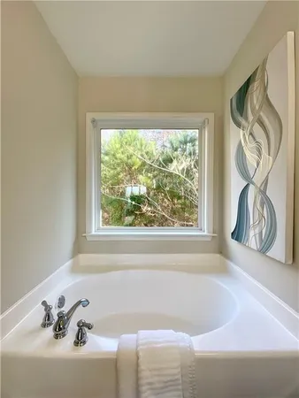 a bath tub sitting in a bathroom next to a window