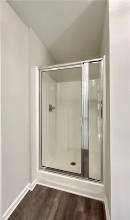 a bathroom with a glass shower door