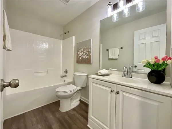 a bathroom with a sink toilet and a mirror