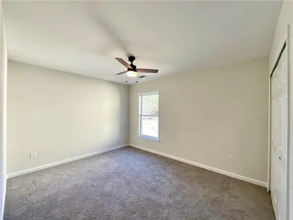 a view of room with window and ceiling fan