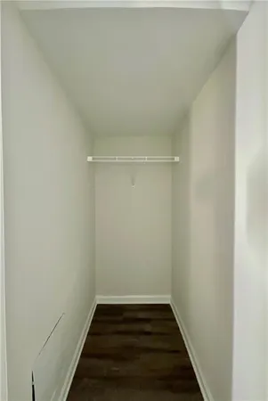 a view of a room with wooden floor and white walls