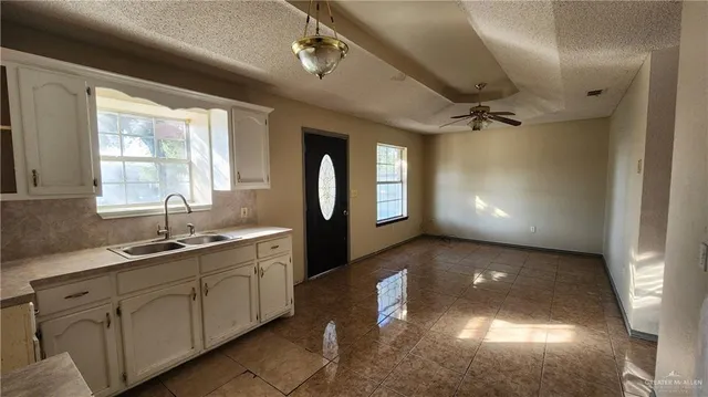 a room with wooden floor a ceiling fan and a window