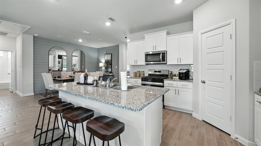 809 Hollyn Drive Decatur, TX 76234 - Photo 31 of 33 Kitchen-All Home and community information, including pricing, included features, terms, availability and amenities, are subject to change at any time without notice or obligation. All Drawings, pictures, photographs, video, square footages, floor plans, elevations, features, colors and sizes are approximate for illustration purposes only and will vary from the homes as built.