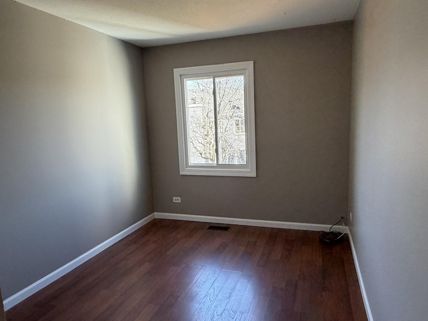 7594 Sarson Way Hanover Park, IL 60133 - Photo 13 of 26 wooden floor and window in an empty room