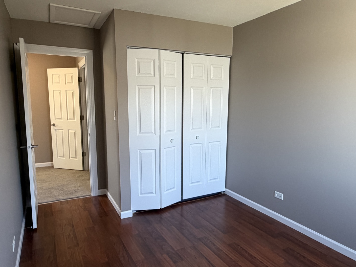 7594 Sarson Way Hanover Park, IL 60133 - Photo 15 of 26 a view of an empty room with wooden floor and closet