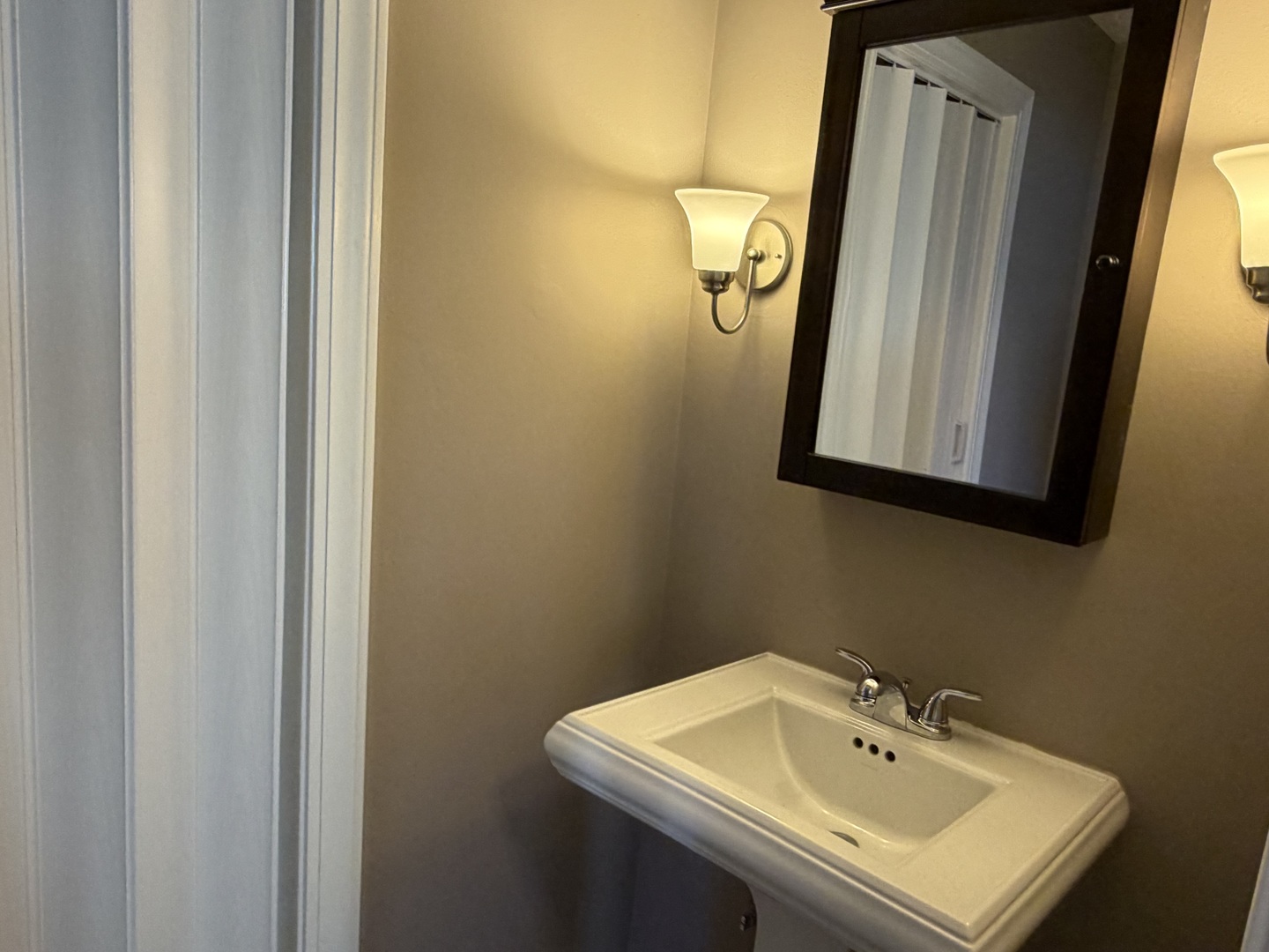 7594 Sarson Way Hanover Park, IL 60133 - Photo 18 of 26 a bathroom with a sink and mirror