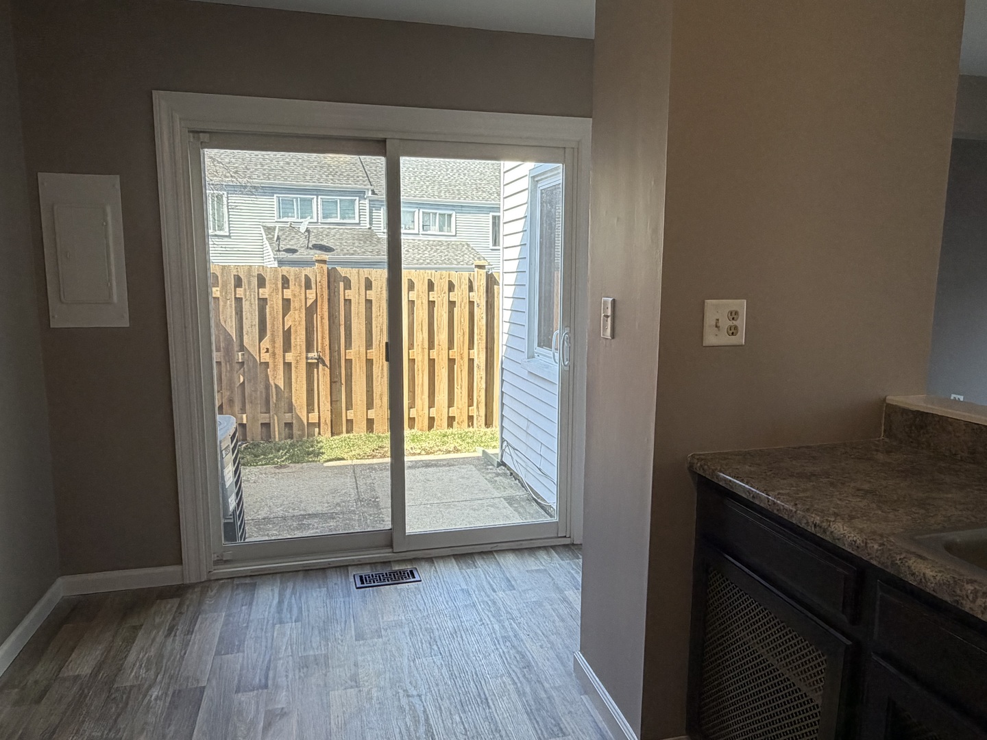7594 Sarson Way Hanover Park, IL 60133 - Photo 20 of 26 a view of an empty room with wooden floor and a window