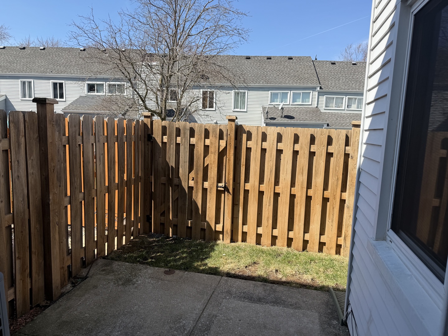 7594 Sarson Way Hanover Park, IL 60133 - Photo 21 of 26 a view of a house with a wooden fence