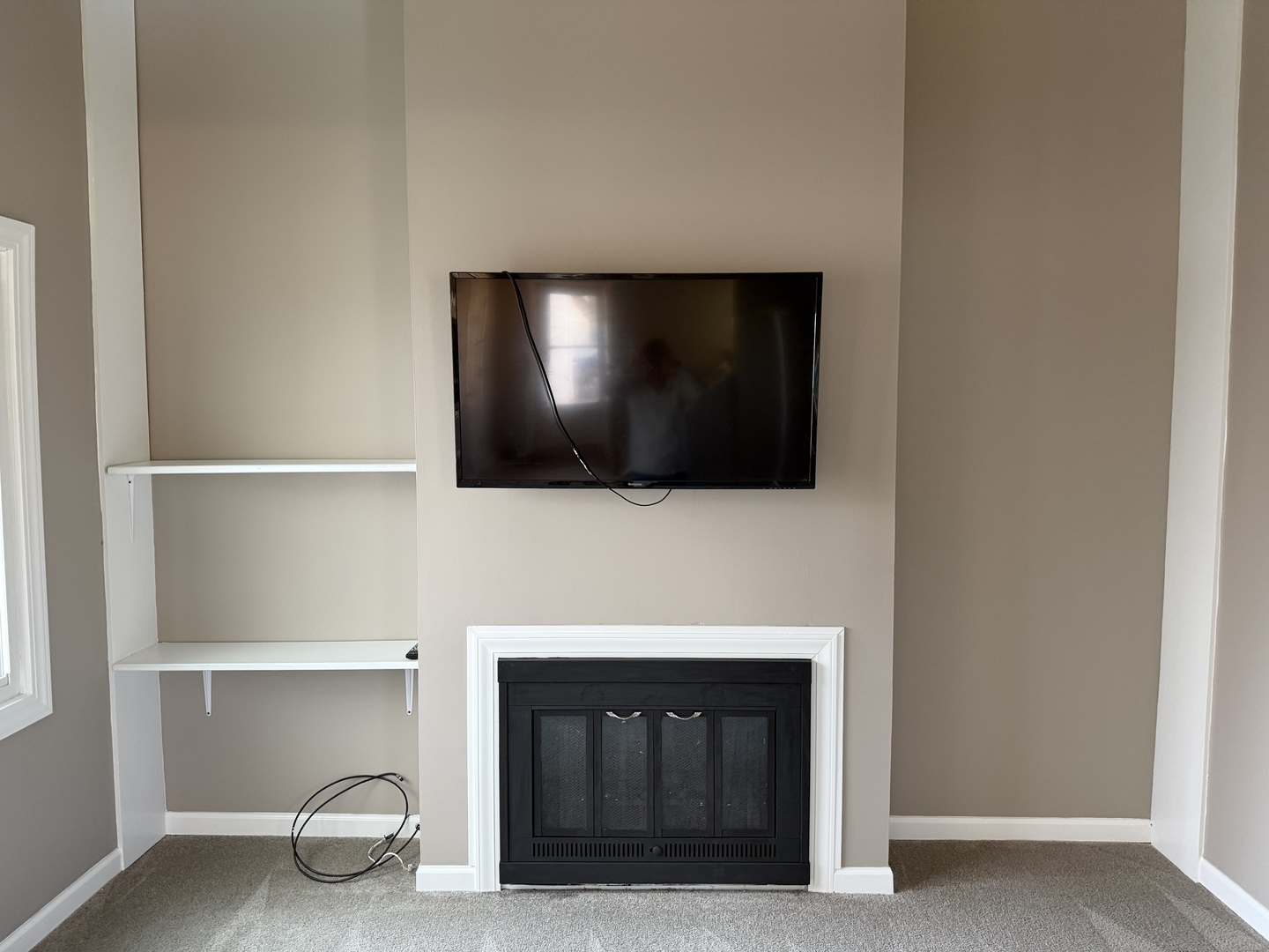 7594 Sarson Way Hanover Park, IL 60133 - Photo 4 of 26 a living room with a fireplace and a flat screen tv