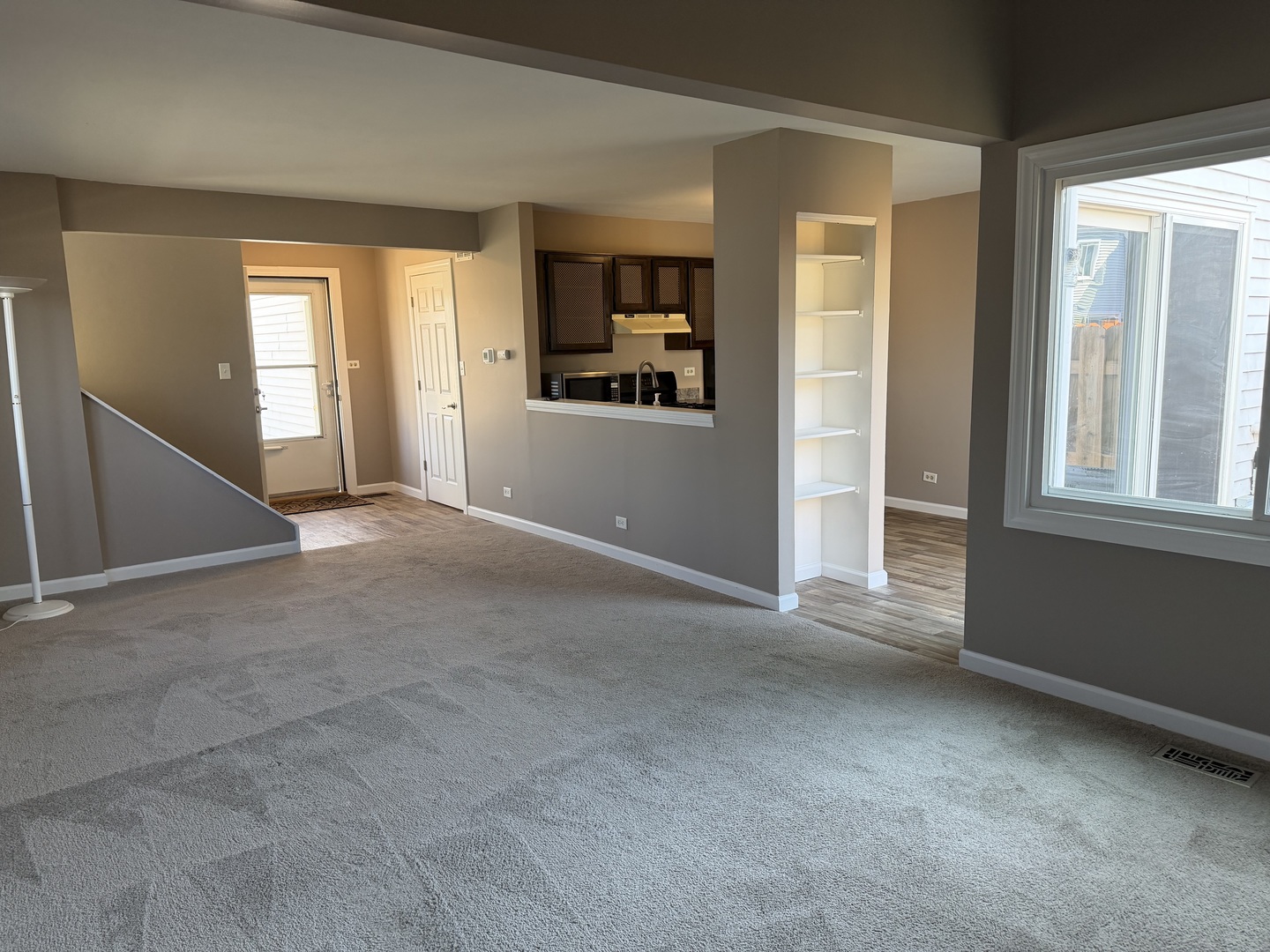 7594 Sarson Way Hanover Park, IL 60133 - Photo 6 of 26 an empty room with windows and cabinet