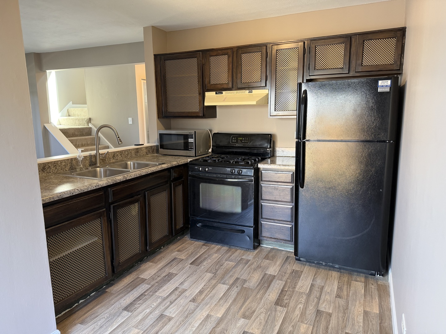 7594 Sarson Way Hanover Park, IL 60133 - Photo 7 of 26 a kitchen with a refrigerator stove and sink