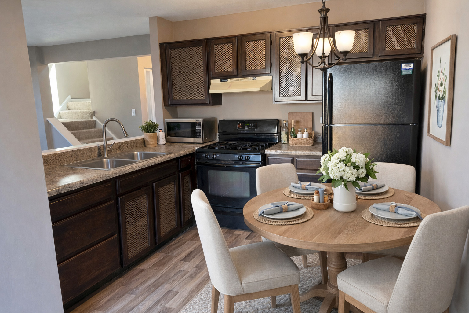 7594 Sarson Way Hanover Park, IL 60133 - Photo 8 of 26 a kitchen with stainless steel appliances granite countertop a dining table chairs and a refrigerator