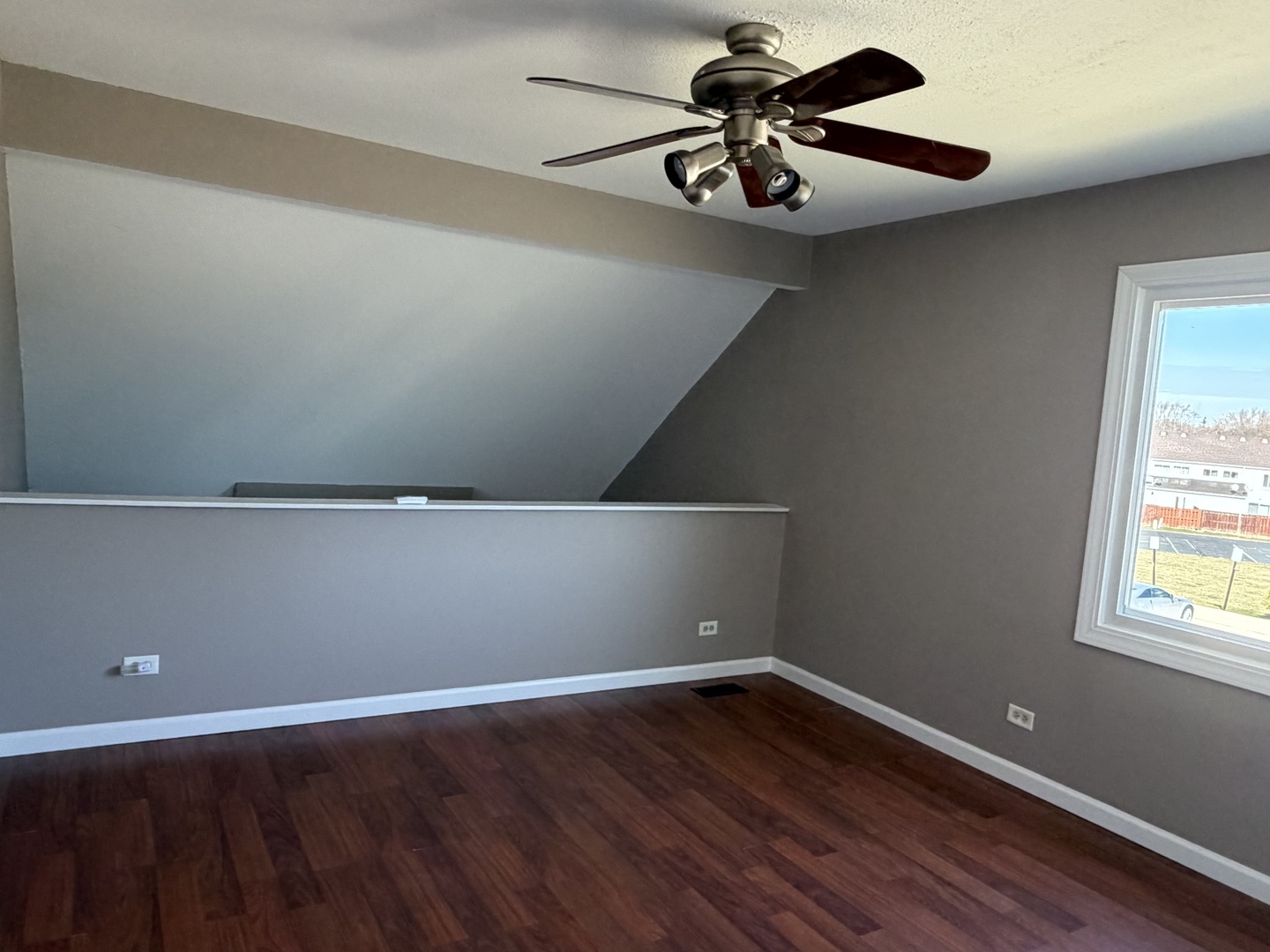 7594 Sarson Way Hanover Park, IL 60133 - Photo 10 of 26 a view of room with hardwood floor and a ceiling fan