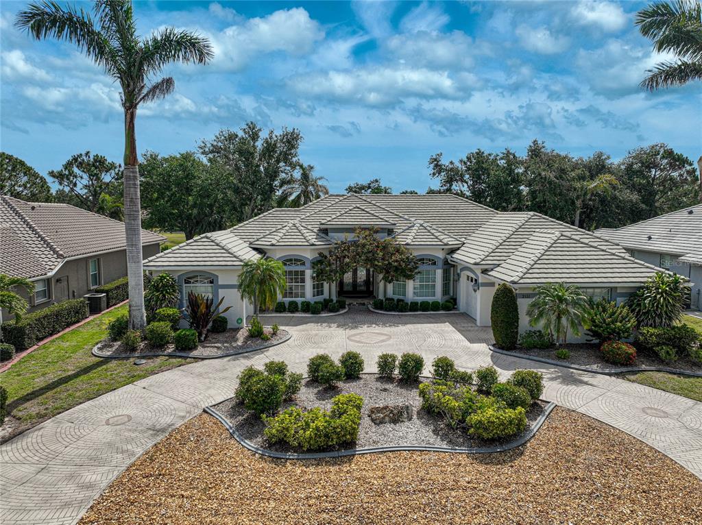 2111 Muskogee Trail Nokomis, FL 34275 - Photo 1 of 58 a view of a patio with table and chairs potted plants and palm trees