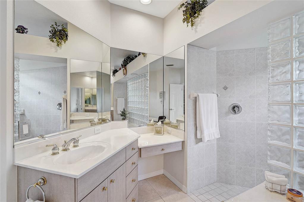 2111 Muskogee Trail Nokomis, FL 34275 - Photo 17 of 58 a bathroom with a sink double vanity and a shower