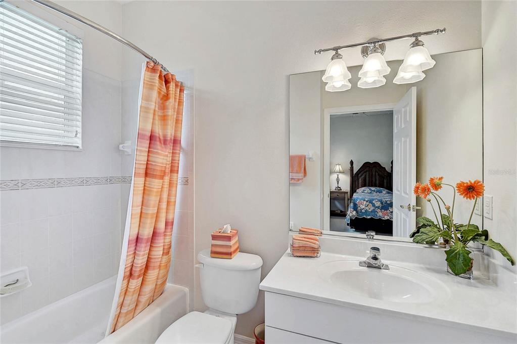 2111 Muskogee Trail Nokomis, FL 34275 - Photo 20 of 58 a bathroom with a sink a toilet and a mirror