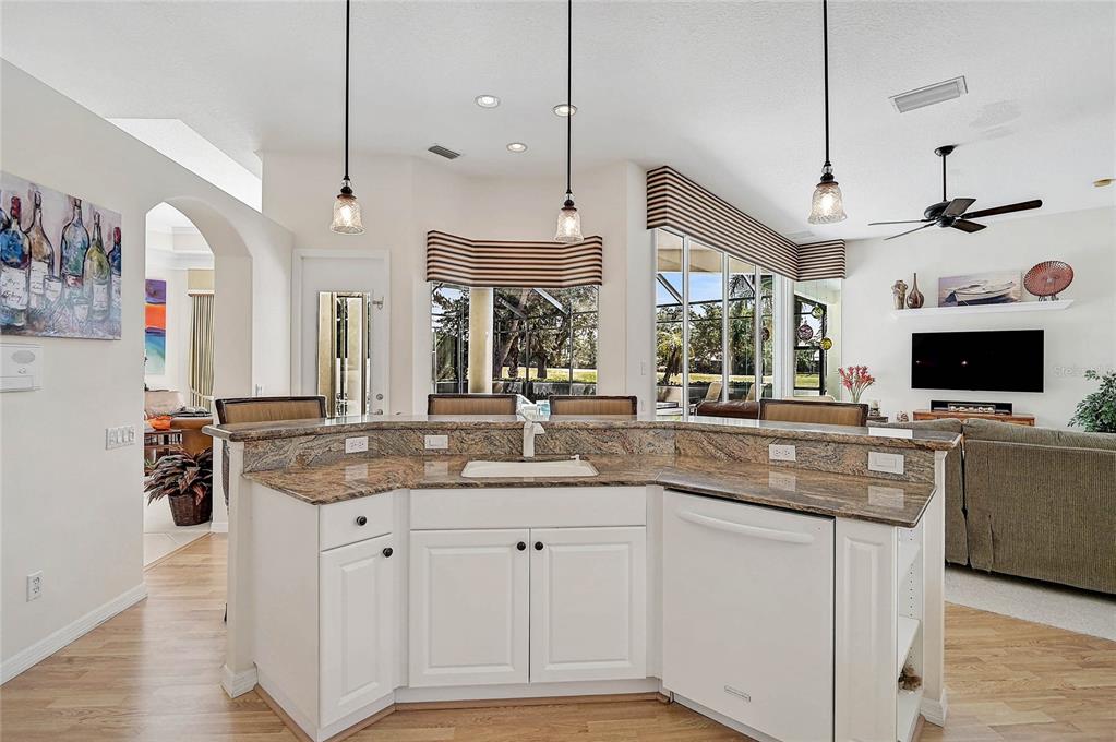 2111 Muskogee Trail Nokomis, FL 34275 - Photo 27 of 58 a kitchen with stainless steel appliances granite countertop a sink and a refrigerator