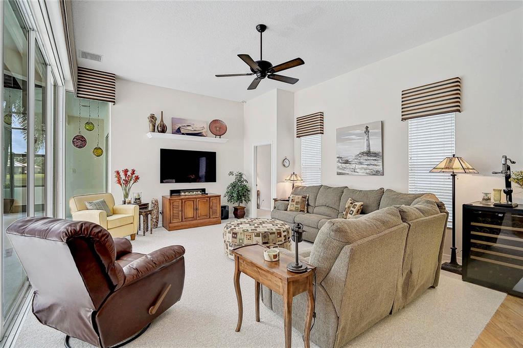 2111 Muskogee Trail Nokomis, FL 34275 - Photo 31 of 58 a living room with furniture a flat screen tv and a window