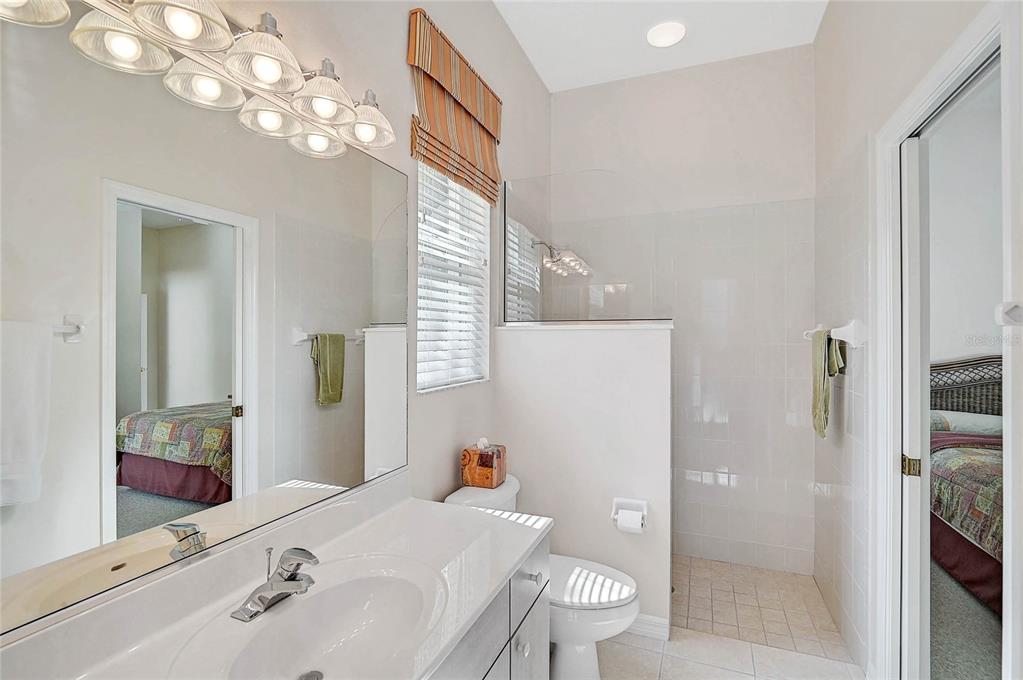 2111 Muskogee Trail Nokomis, FL 34275 - Photo 36 of 58 a bathroom with a sink a toilet and shower