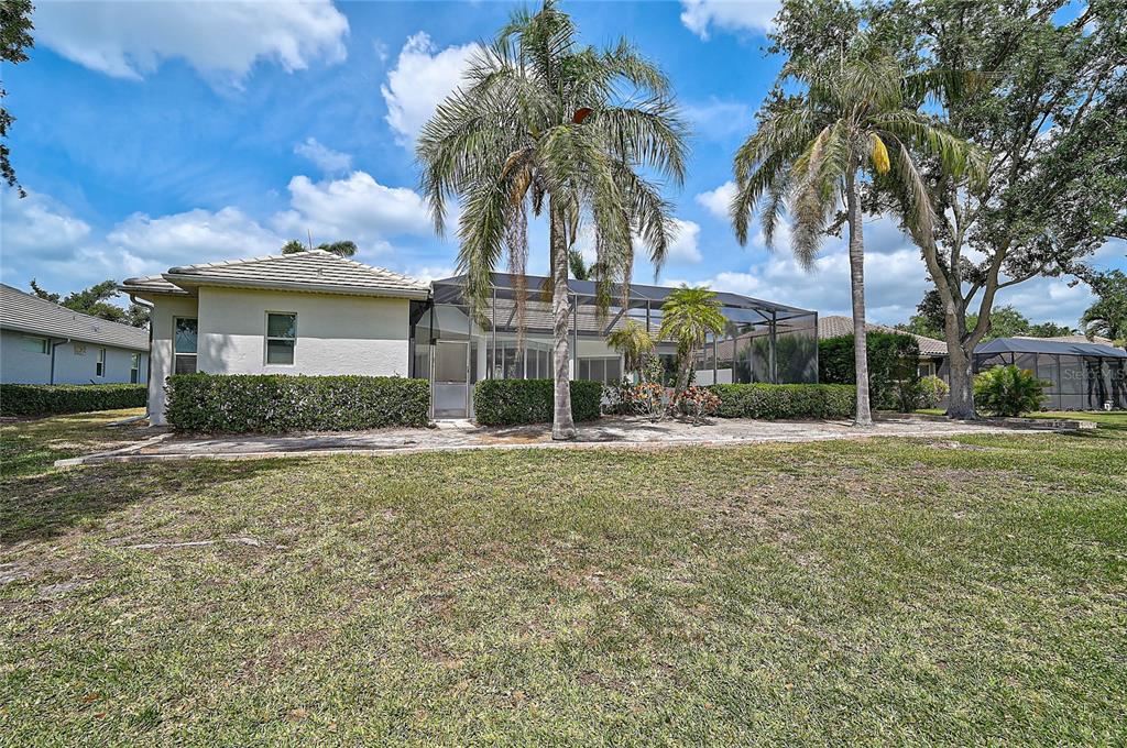 2111 Muskogee Trail Nokomis, FL 34275 - Photo 42 of 58 a view of a house with a yard and palm trees