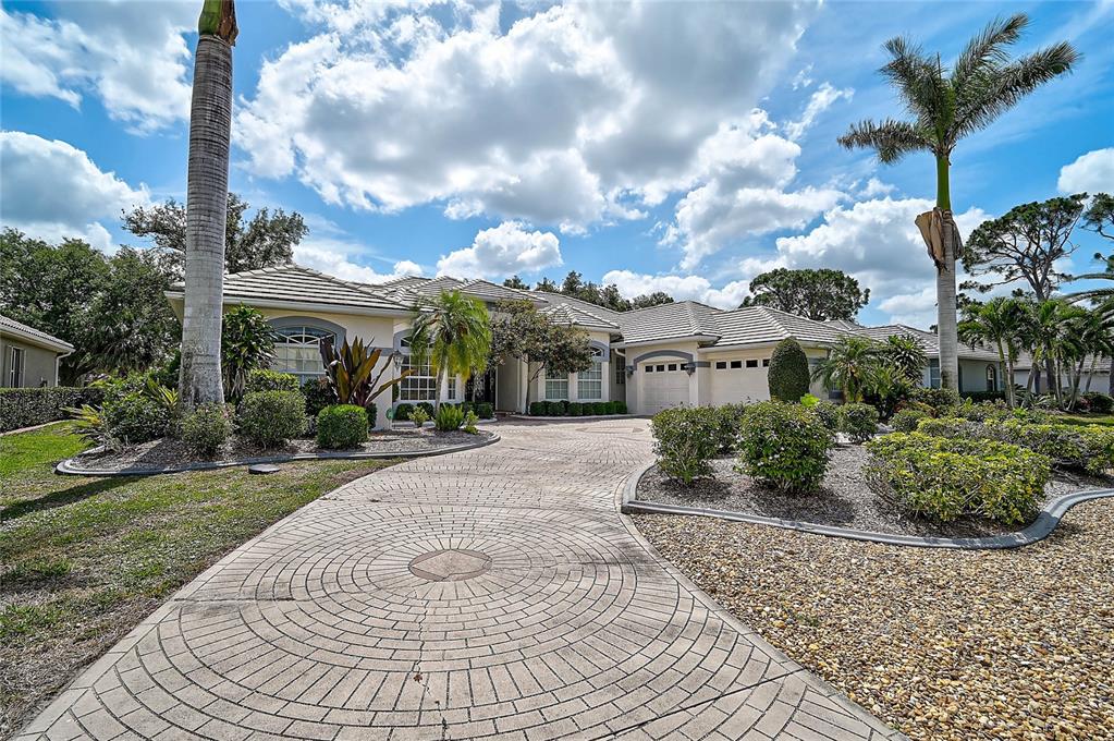 2111 Muskogee Trail Nokomis, FL 34275 - Photo 47 of 58 a view of a white house next to a yard
