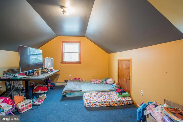 a bedroom with bed and window
