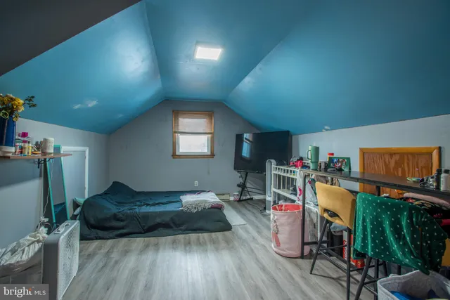 a bedroom with furniture and a wooden floor
