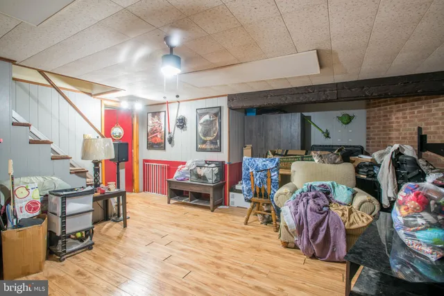 a living room filled with furniture and a wooden floor