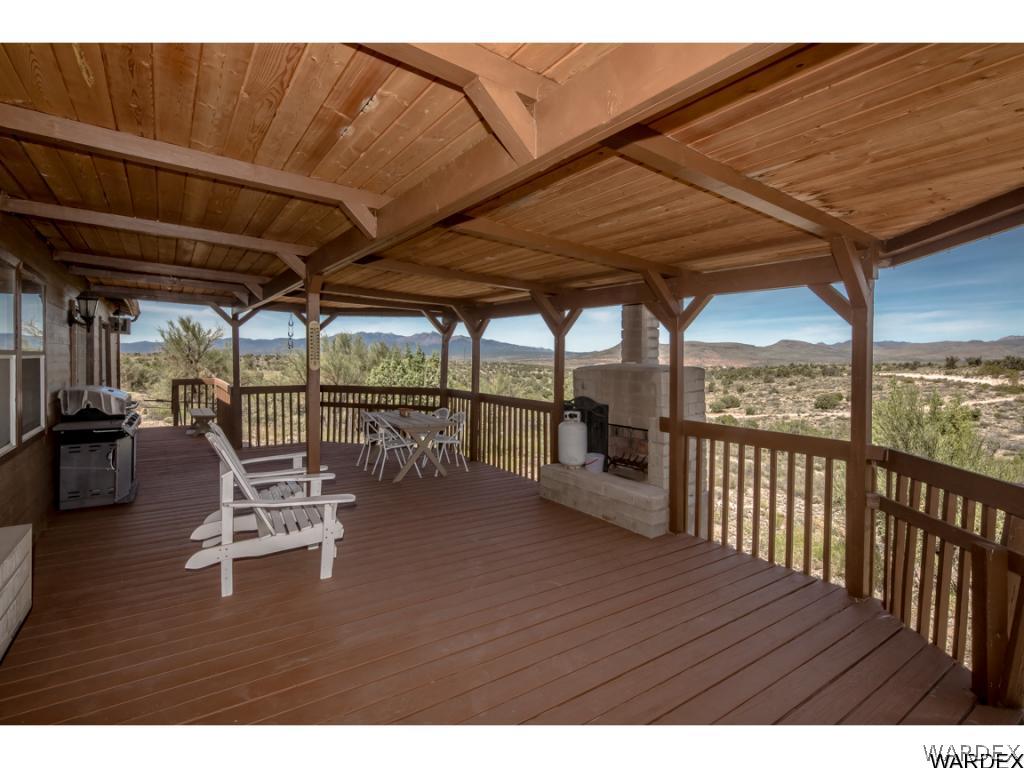 14760 Powerline Road Kingman, AZ 86401 - Photo 14 of 36 a roof deck with table and chairs and wooden floor