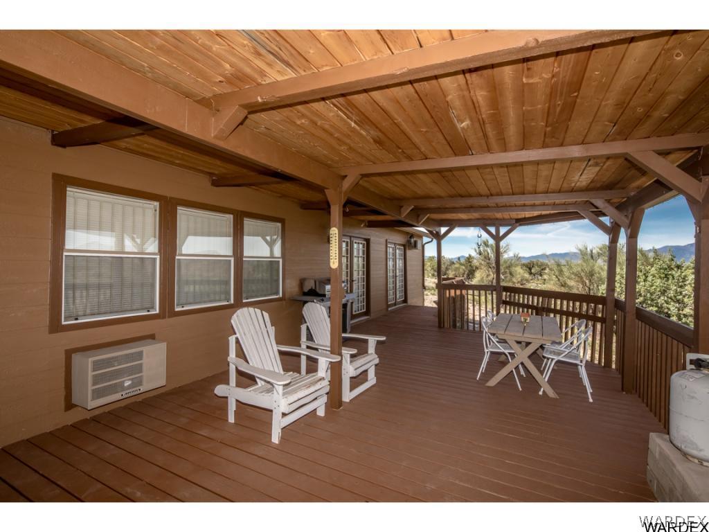 14760 Powerline Road Kingman, AZ 86401 - Photo 15 of 36 a living room with furniture a wooden floor and a table