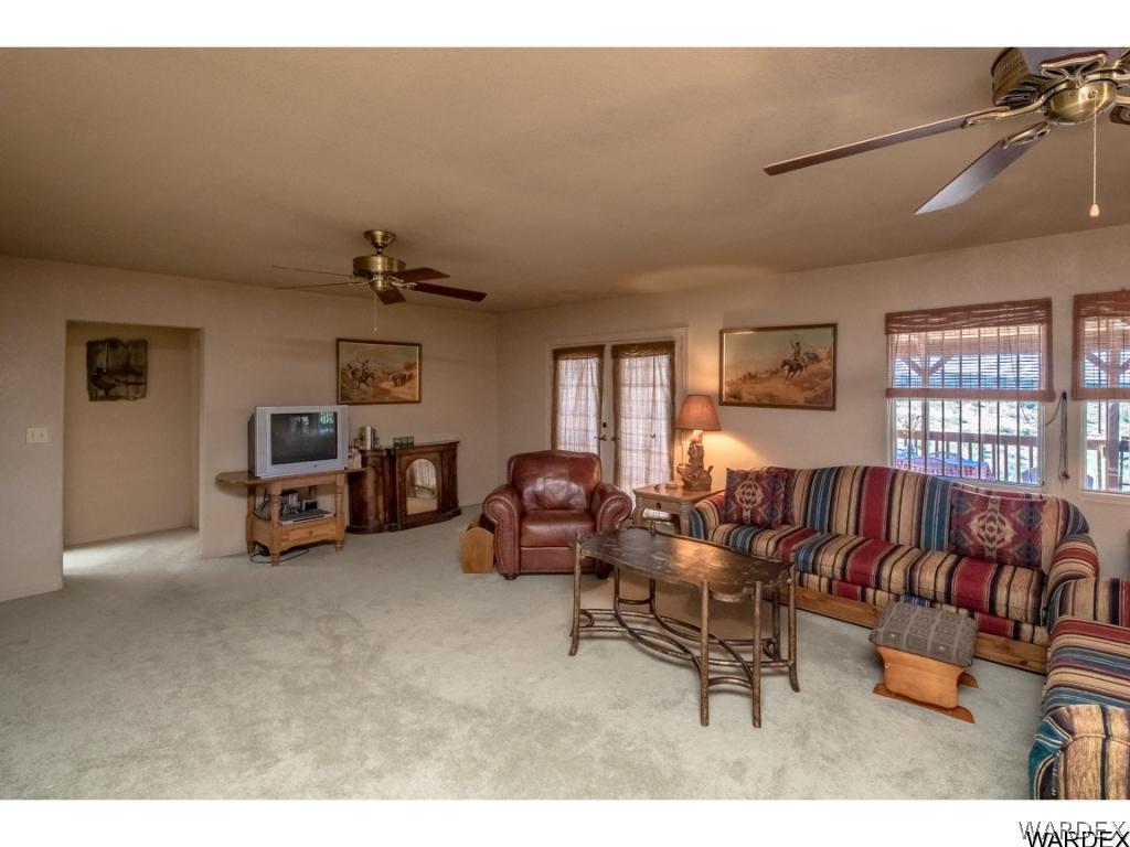 14760 Powerline Road Kingman, AZ 86401 - Photo 17 of 36 a living room with furniture and a flat screen tv
