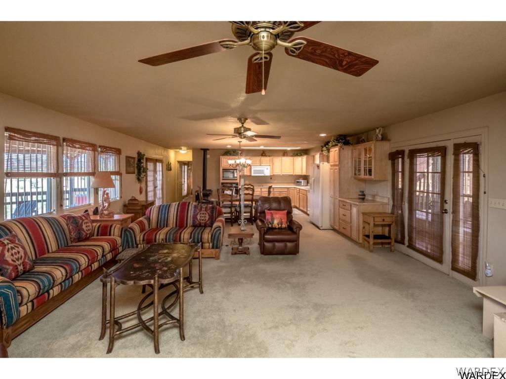 14760 Powerline Road Kingman, AZ 86401 - Photo 20 of 36 a living room with lots of furniture and a chandelier
