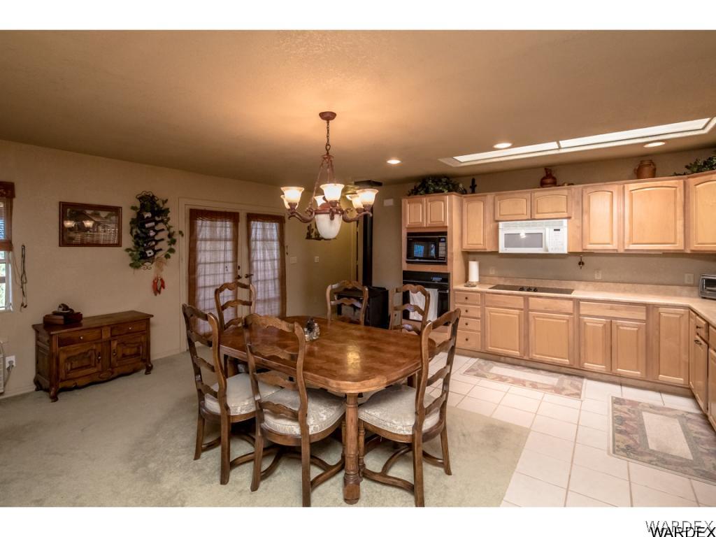 14760 Powerline Road Kingman, AZ 86401 - Photo 21 of 36 a view of a dining room with furniture and chandelier